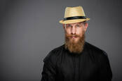 Bearded hipster gent wearing straw fedora