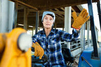  farmer sitting on a tractor at the cowfarm
