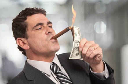Man lights his cigar with a $100 bill