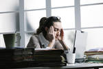 IT worker with head in hands