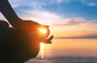 Person meditating on beach