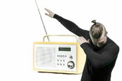 man dabs in front of DAB radio