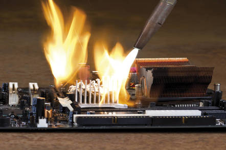 A blowtorch burning a computer board