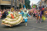 Parade of dancers in costume at  London's Notting Hill carnival. 