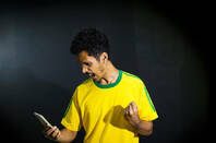 A sports fan looking at a phone