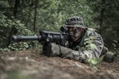 Special forces soldier lying on the ground, preparing to shoot