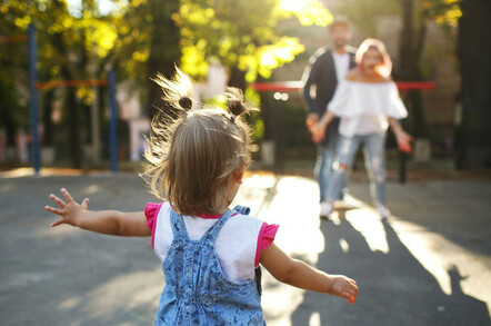 Child running to parents at park