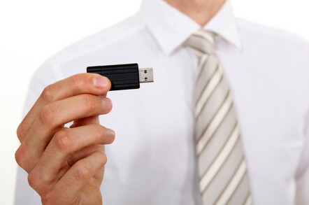 Businessman holding USB stick