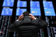 Stock market trader worries looks at board