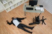Man lying unconscious on office floor
