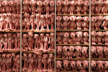 shelf filled with many sizes of pink panther dolls