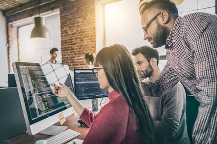 Some programmers looking at a screen