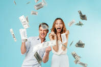 Money falling on a guy and woman