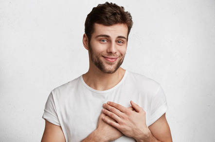 A man holds his heart, looks honest