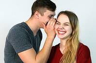 Someone whispering a secret to another