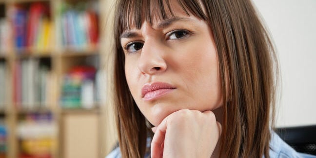 Sceptical woman wears an incredulous expression, scrunches eyes