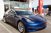 California January 6, 2018: navy tesla model 3 charging at supercharger station Aleksei Potov / Shutterstock.com