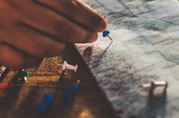 Road map with pin being inserted