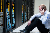 man on mobile phone in a data centre