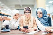 Three women looking at their phones
