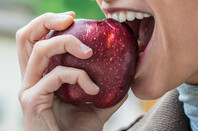 Person eating an apple