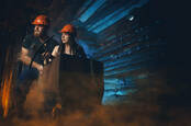 Two miners (cosplay) carrying coal up "mine shaft" - 