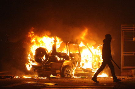 Dissident walking away from burning vehicle