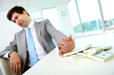 disgusted man in suit refuses money