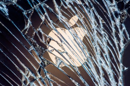 Apple logo behind broken window