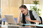 Man has panic attack in front of computer