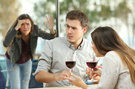 Obsessed ex girlfriend spying on an annoyed couple dating in a restaurant