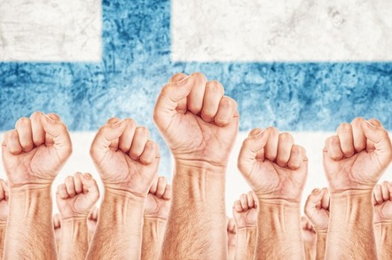 Fists raised in front of Finland's flag