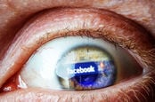 panicked eye with Facebook logo reflected on surface
