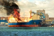Cargo ship in port, burning