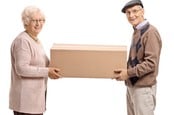 Elderly woman and man holding a cardboard container