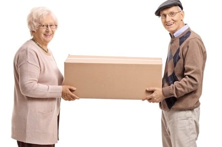 Elderly woman and man holding a cardboard container