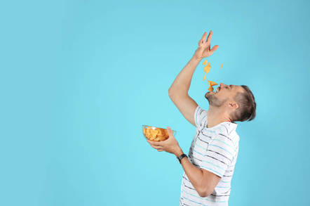 man pours chips on face