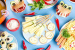 cheese arranged in a spooky way (broomsticks/fingers) on a platter