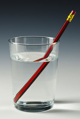 A straw in a glass of water shows how light refracts differently in the liquid. Pic: Shutterstock/Pat Hastings