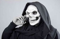 A skeleton talking on a mobile phone