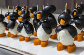 penguin entree army - black olives, carrot pieces and mozzarella balls pierced by toothpicks