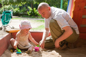 playing in the sandbox with buckets and spades