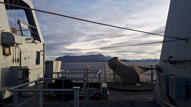 A rocky outcrop framed by HMS Enterprise