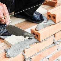 builder does the wet cement work on brick wall.. trump shutdown