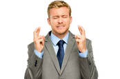 man crossed fingers anticipation