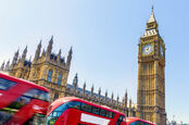 parliament buildings with buses going by 