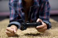 Frustrated female gamer loses another match and angrily slams fist on the floor