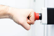 Picture of a person's fist hitting an emergency red button