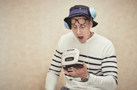 hipster shocked at compact disc player