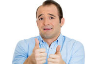 A man gives a reluctant thumbs up